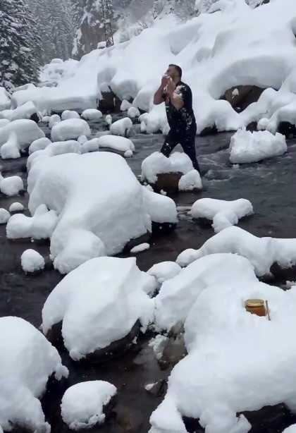 Kar ve soğuğa aldırmadı, ürününü tanıtmak için dereye girdi